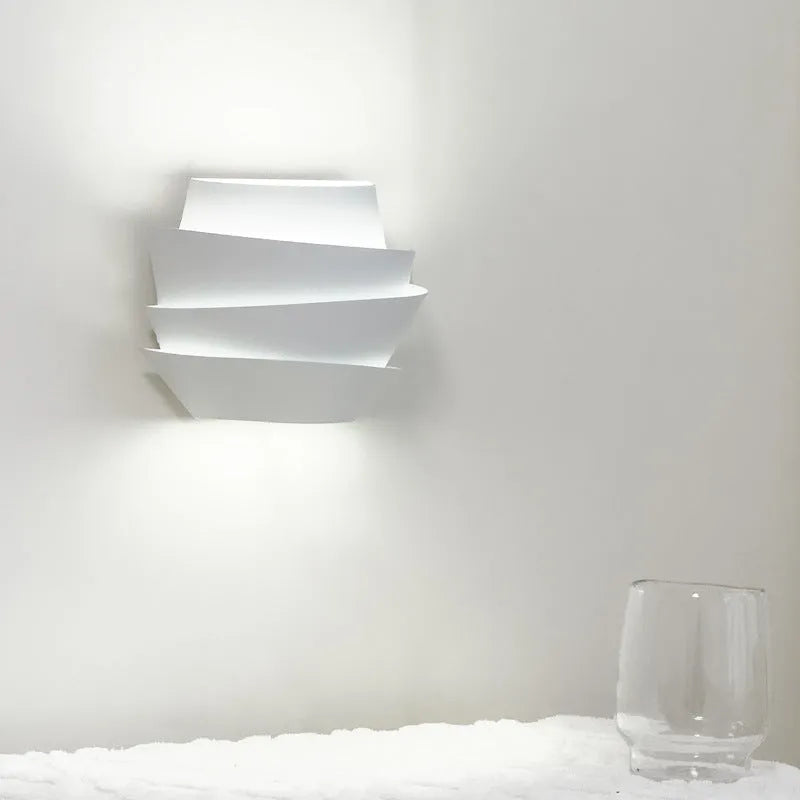 White modern wall lamp with pine cone silhouette design for bedroom or hallway lighting