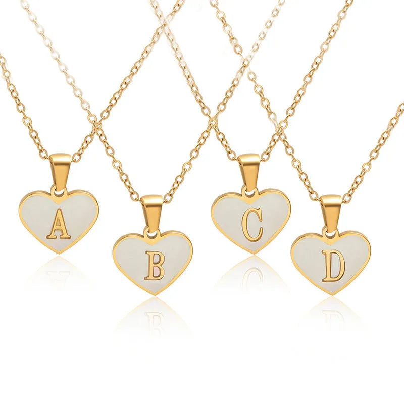 Gold-plated heart necklace with white shell centre and personalised letter pendant on 45cm chain