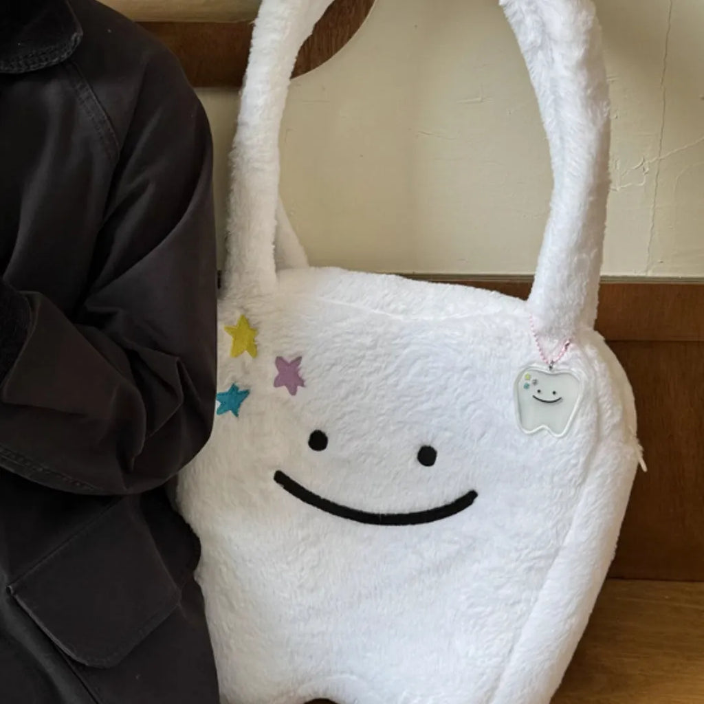 White plush large tooth design shoulder tote bag with crossbody strap and zipper opening