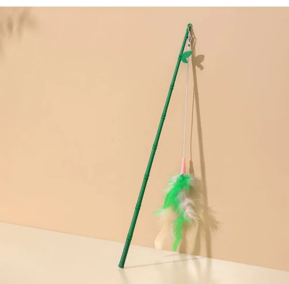 Green interactive cat feather wand toy with bell attachment on a durable stick