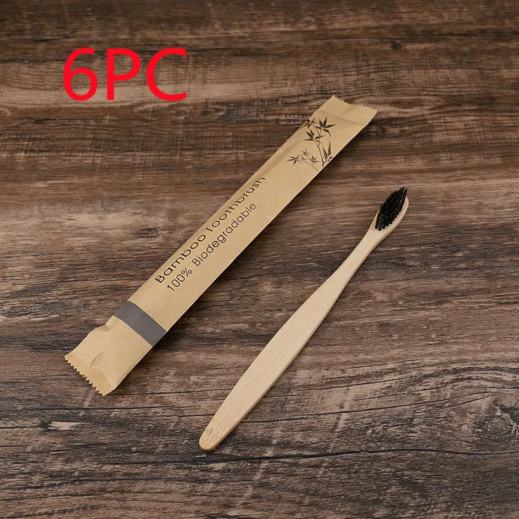 Set of ten bamboo toothbrushes with charcoal bristles in assorted colours on a plain background