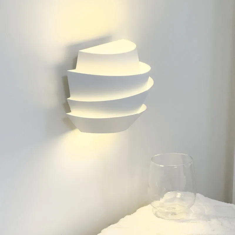 White modern wall lamp with pine cone silhouette design for bedroom or hallway lighting
