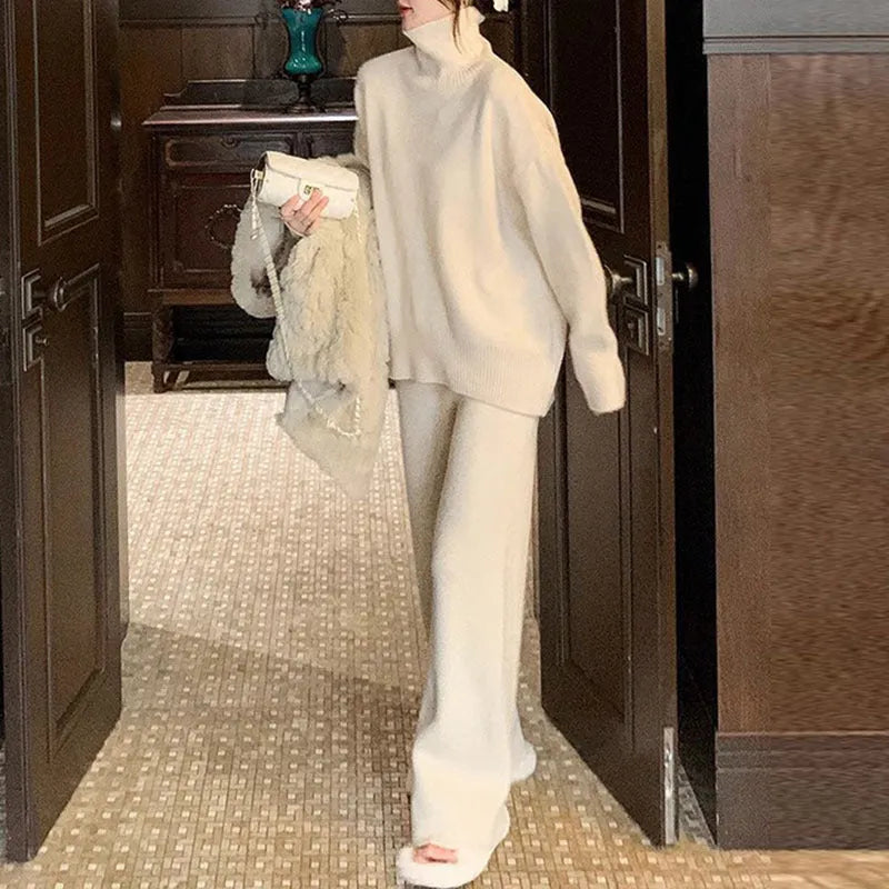 Women's milky white acrylic two-piece set with long sleeve top and wide-leg trousers on a hanger.