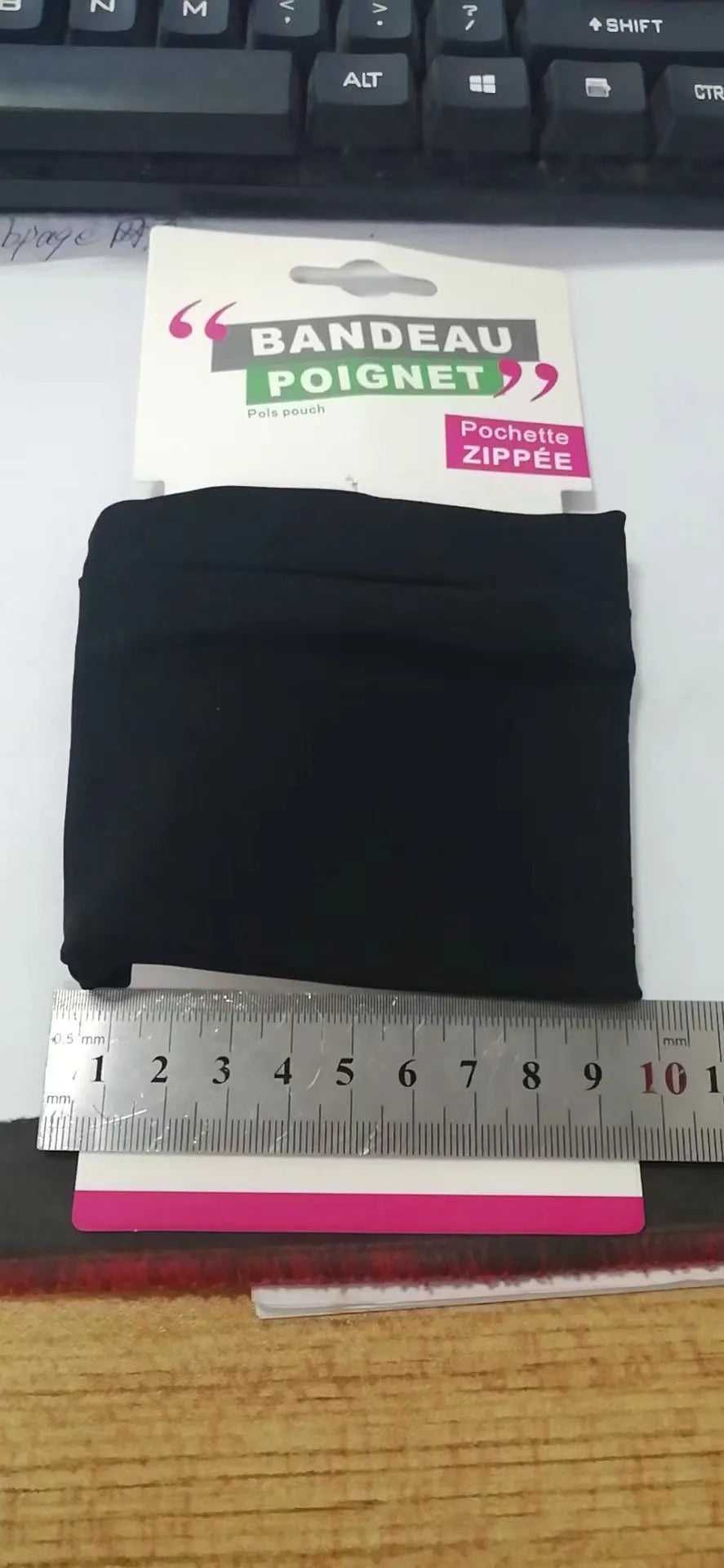 Adjustable fitness wrist bag with armband sleeve for mobile phone, shown in packaging.