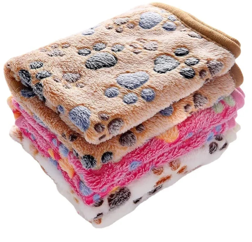 Coral fleece pet blanket with dog paw print pattern shown in beige colour, lying flat to show size
