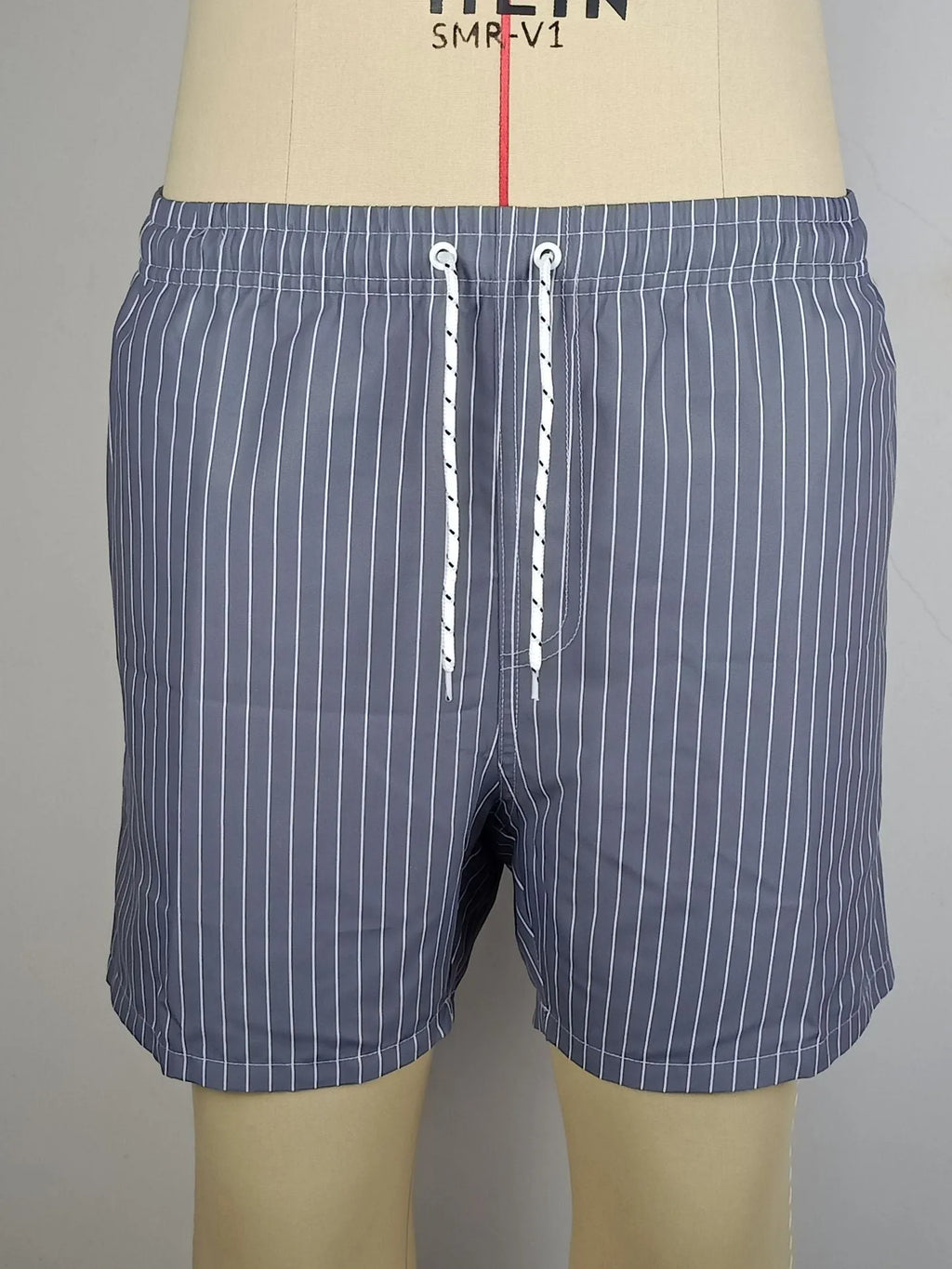 Striped polyester fibre beach shorts with triangle lining in navy blue, straight leg design