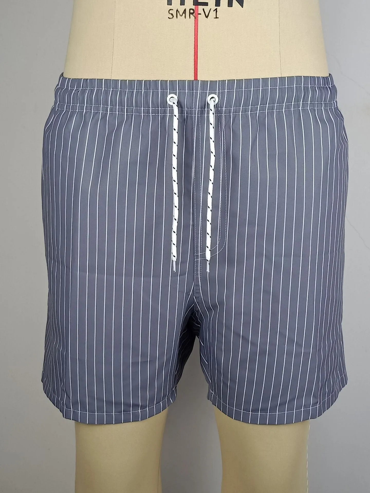 Striped polyester fibre beach shorts with triangle lining in navy blue, straight leg design