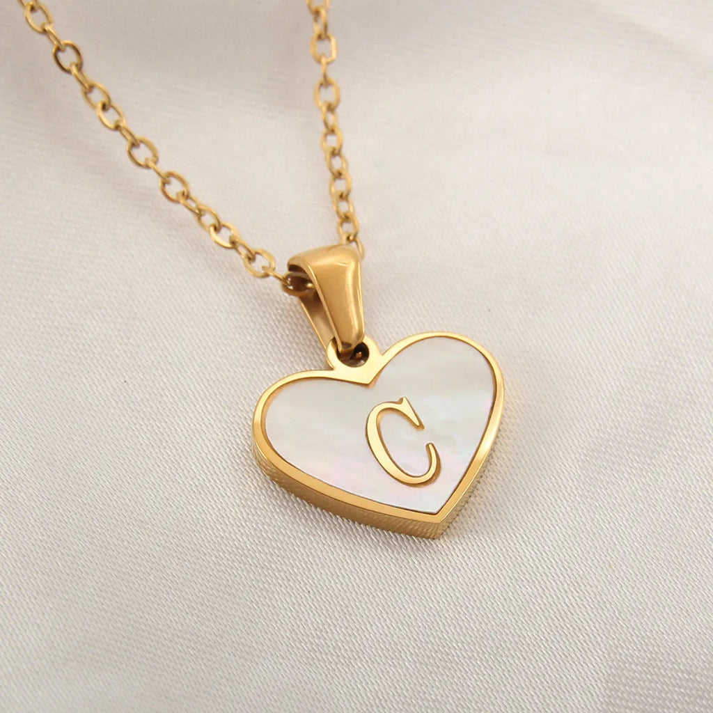 Gold-plated heart necklace with white shell centre and personalised letter pendant on 45cm chain