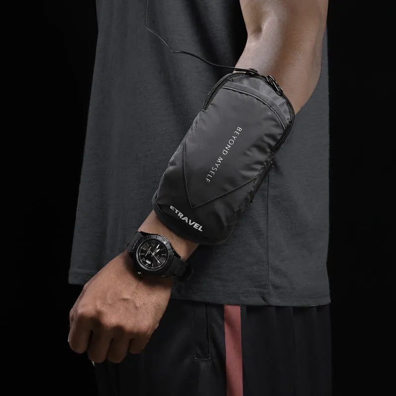 Black reflective running arm bag with adjustable strap, shown on a runner's arm at dusk.