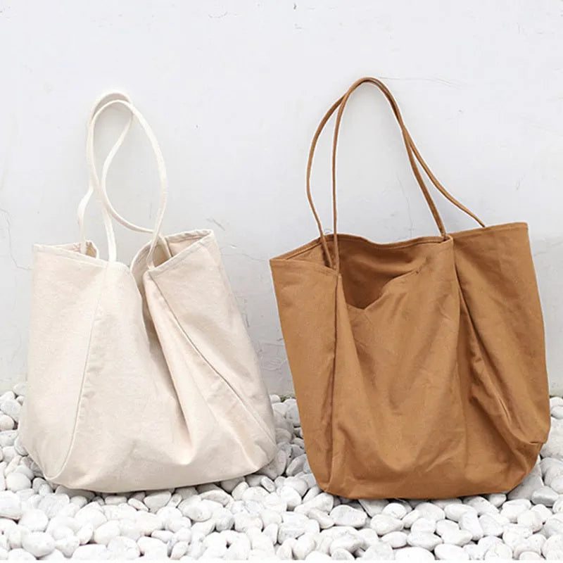 Large canvas shoulder tote bag in solid colour with soft handle, open top, and internal phone pocket