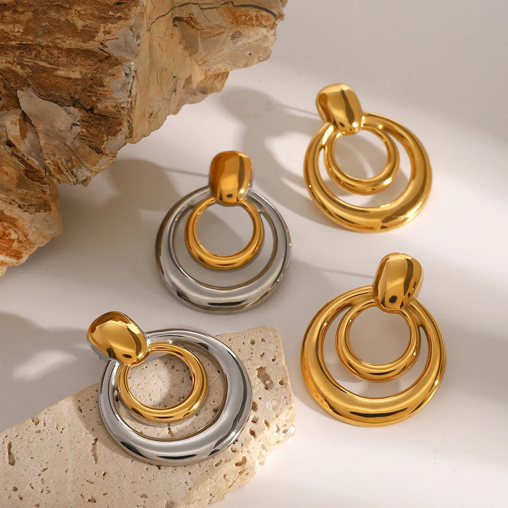 Golden titanium steel stud earrings with double-layer hollow design and round geometry shape