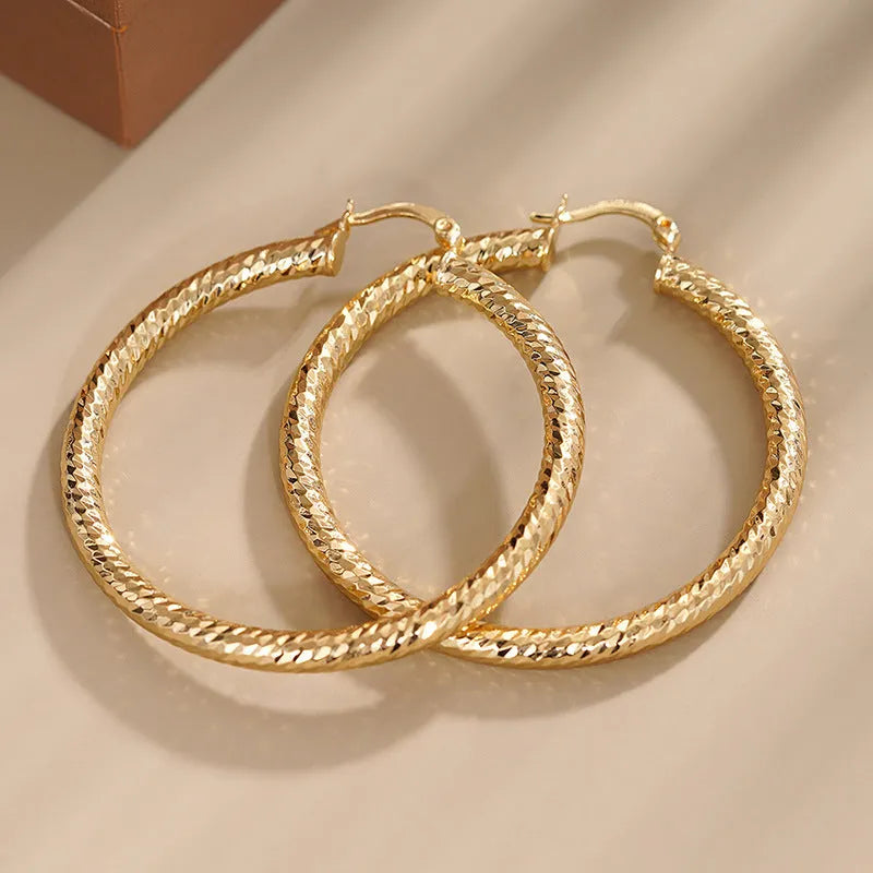 Women's geometric ear clip earrings with drop-shaped ring design in copper with electroplated finish