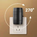 A small white plug-in night light with an adjustable head, shown next to a power socket for scale.