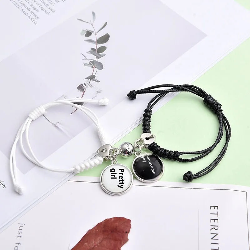 Magnet suction couple bracelets with alloy construction and various pendant designs including crowns and hearts