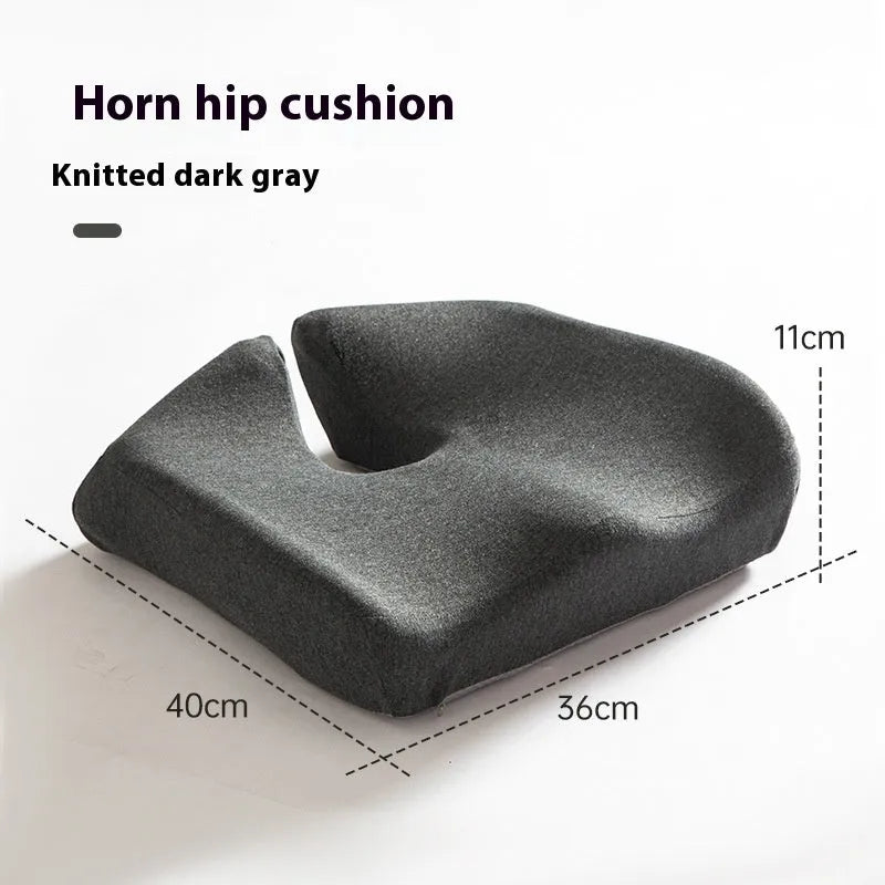 Dark grey memory foam office chair cushion for lumbar support on a desk chair.