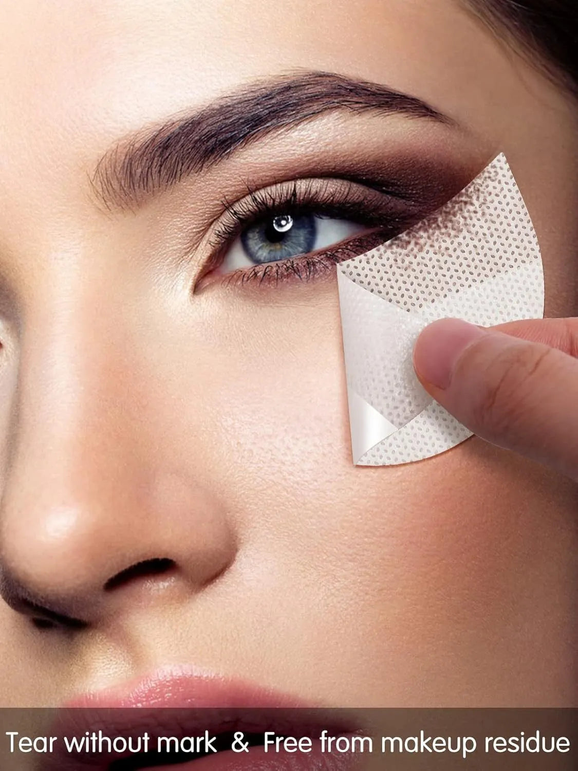 Pack of half-moon shaped disposable under-eye makeup shields on pink background