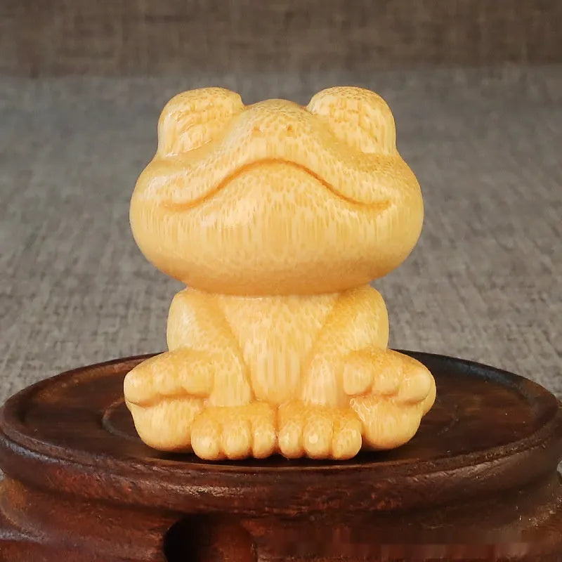 Solid bamboo smiling frog carving ornament measuring 5cm high with cartoon cute style