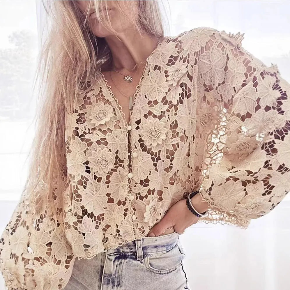 Women's black V-neck lace shirt with white three-dimensional flower decoration and long sleeves.
