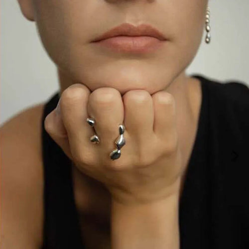 Brass spherical ring for women in gold or silver colour on a circular band.