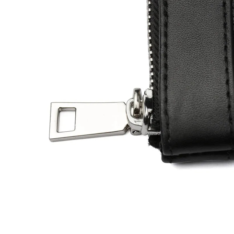 Men's black leather clutch wallet made from cowhide, showing plaid texture and open view of polyester lining.