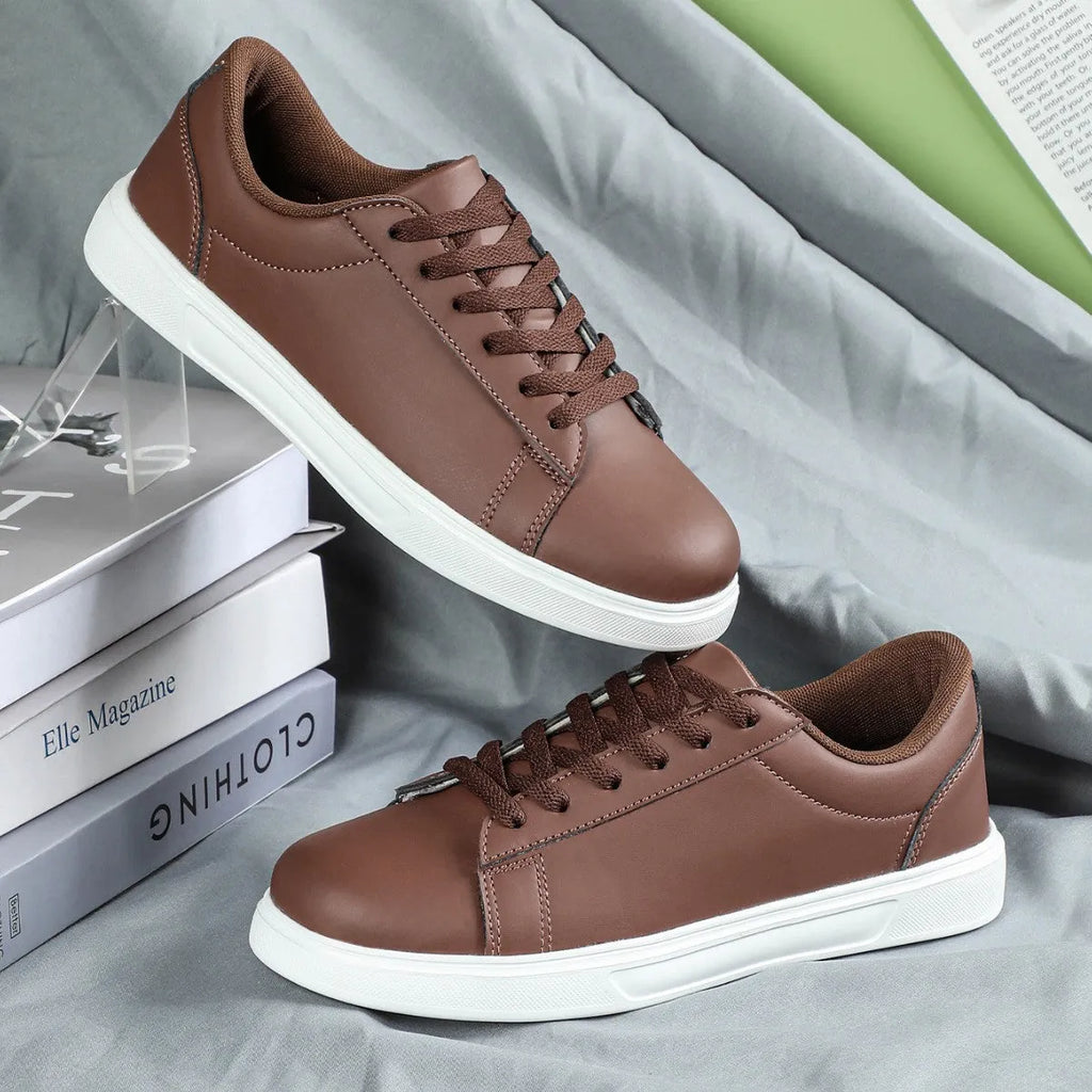 Platform skateboard casual sneaker in beige brown with low top, round toe, and a cross strap detail.
