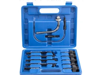 13-piece transmission oil refuelling kit showing injector tool and assorted connectors on a workbench