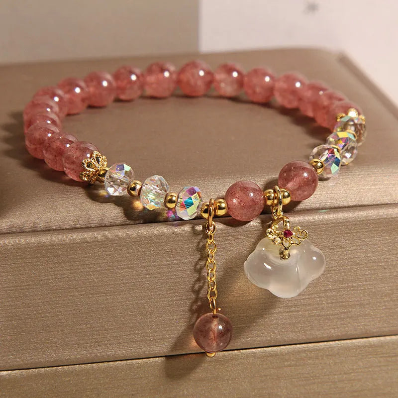 Women's adjustable crystal bracelet with strawberry quartz and white agate beads featuring auspicious cloud charm