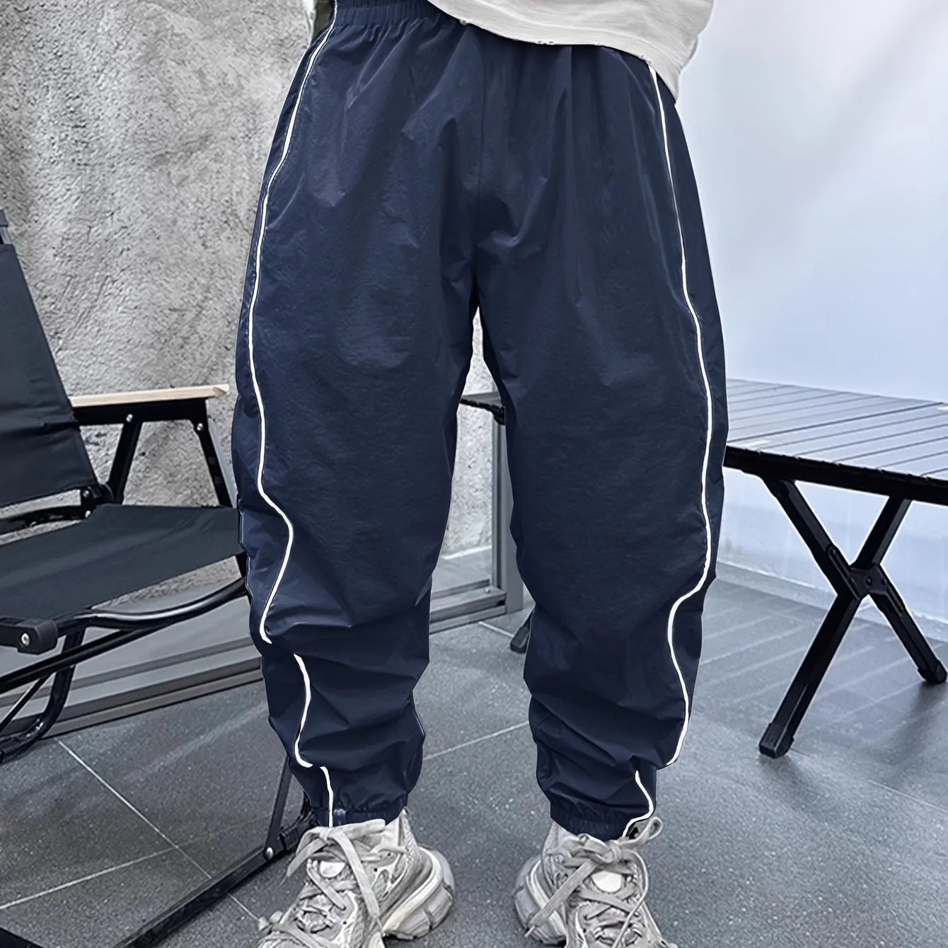Men's blue bamboo fibre casual sports trousers with cropped length and loose fit on a hanger.