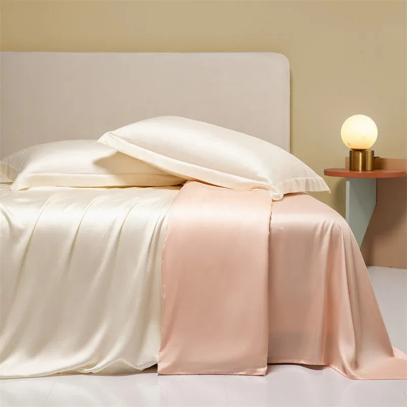 Luxury Lenzing Tencel bedding set in Aurora Blue on a bed, showing quilt cover, sheet, and two pillowcases.