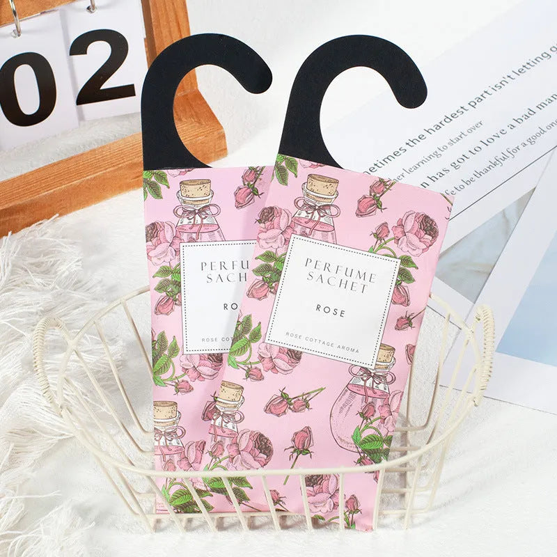 Pack of five household wardrobe sachets with lavender, rose, jasmine, sandalwood, vanilla, apricot blossom aromas on a shelf