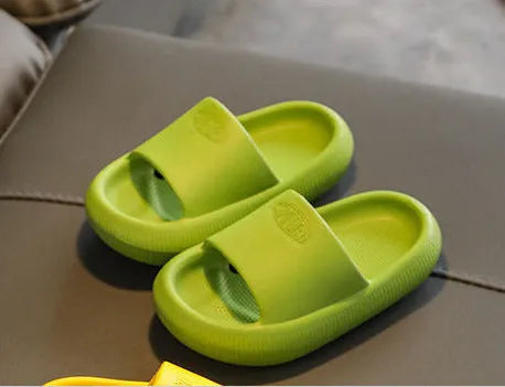 Colourful children's EVA slippers with textured sole, shown in blue, green, orange, pink, and yellow.