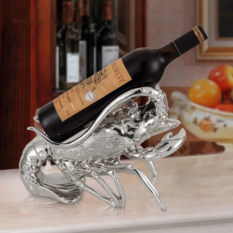 Lobster-shaped decorative wine rack ornament in rose gold or silver finish on a tabletop.