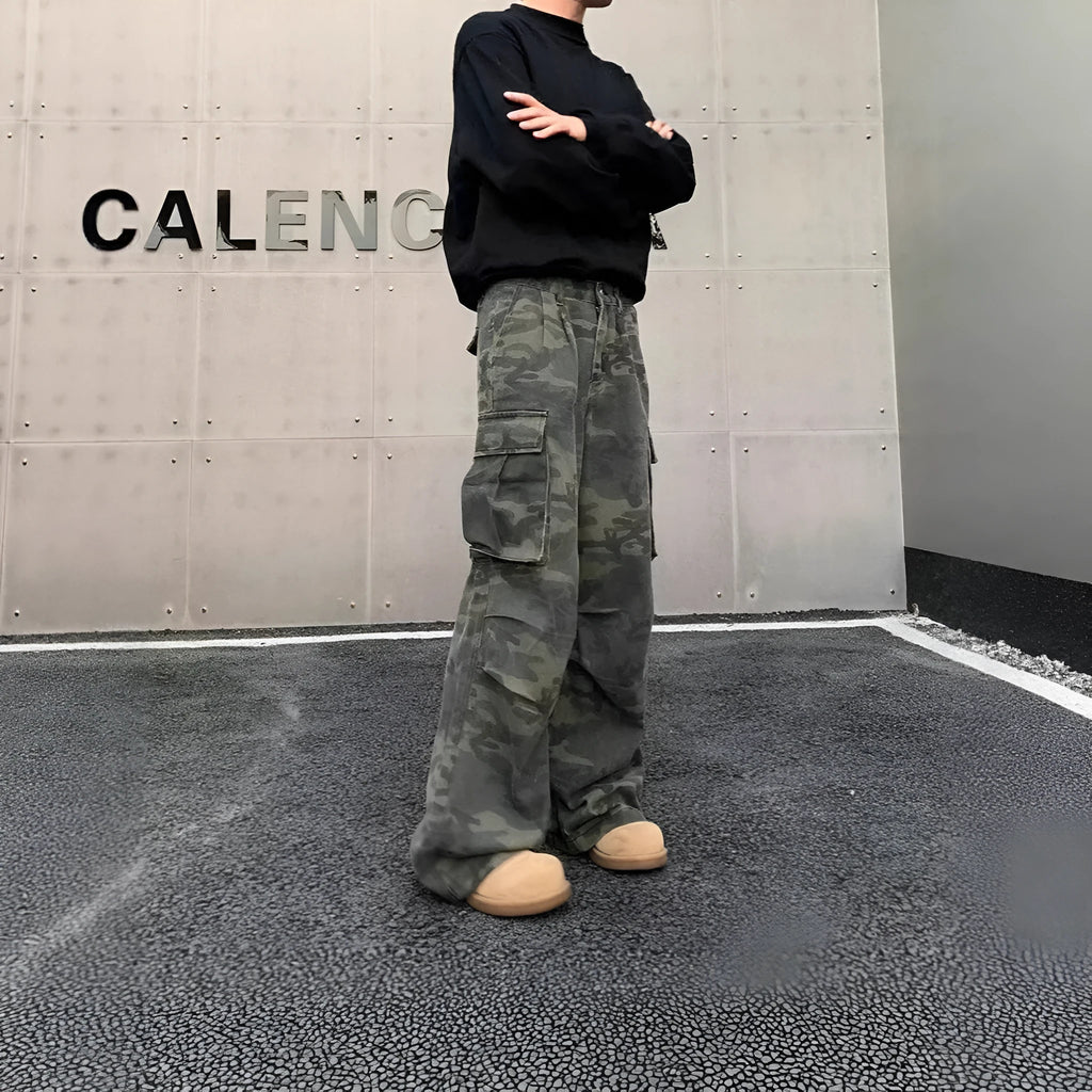 Men's loose-fit camouflage cargo pants with multiple pockets on a washed vintage-style fabric.