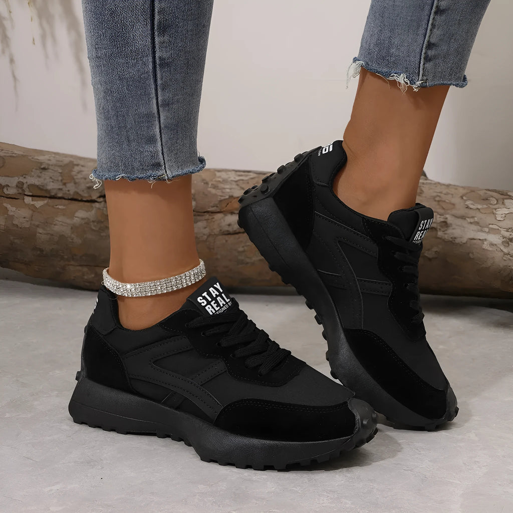 Black mesh sports flat shoes for women with synthetic leather upper and rubber sole, side view