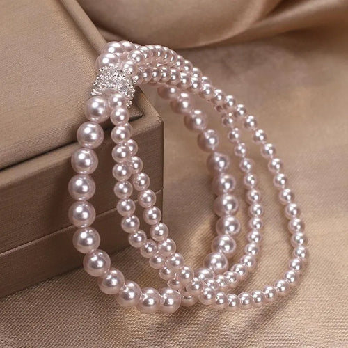 Baroque pearl multi-layer twin bracelet with pink and white imitation pearl beads on display