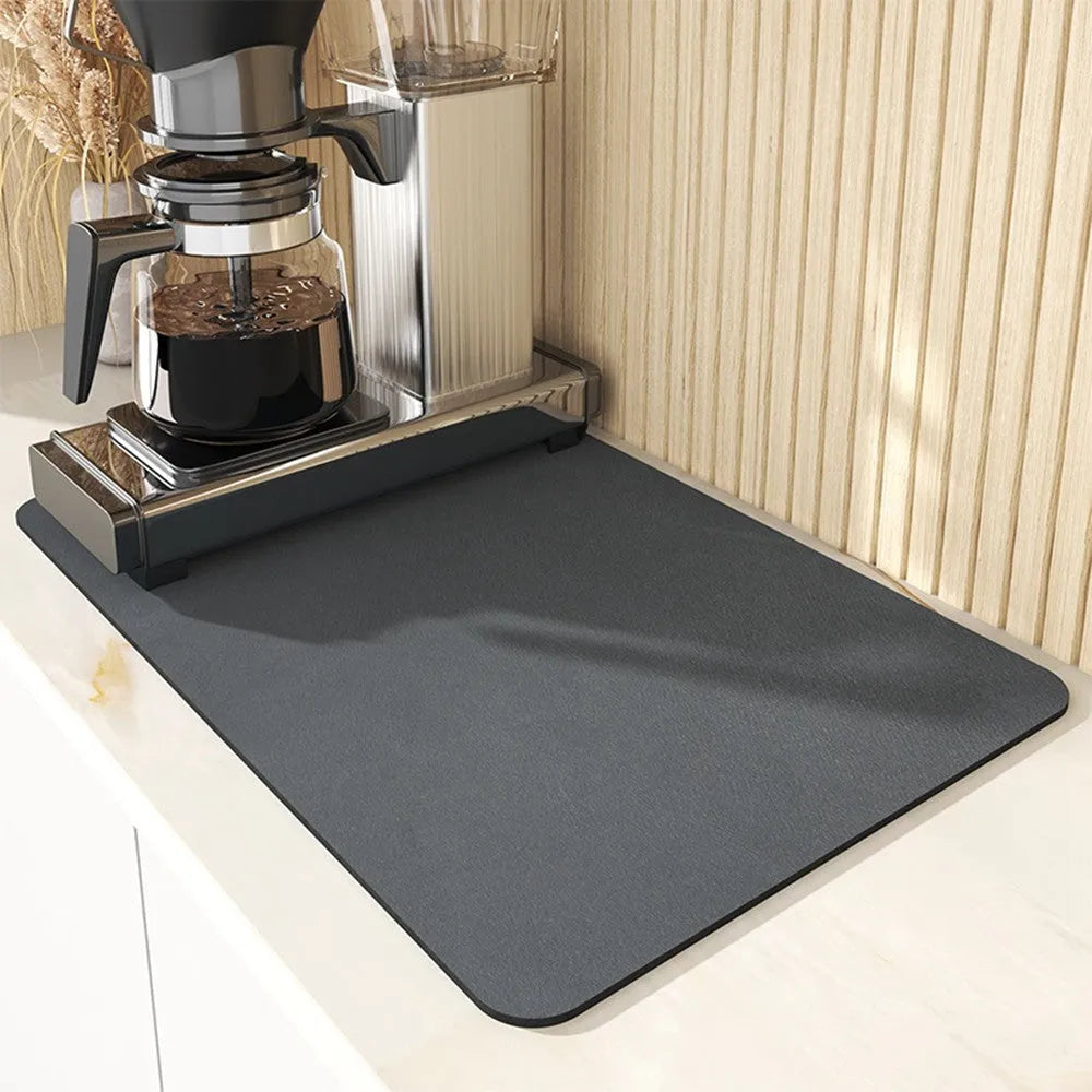 Black square kitchen drain drying mat with anti-slip rubber backing on a countertop