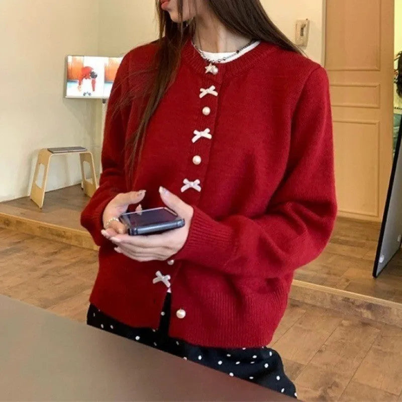 Women's cashmere cardigan sweater with bow accent and pearl buttons in nine colour options