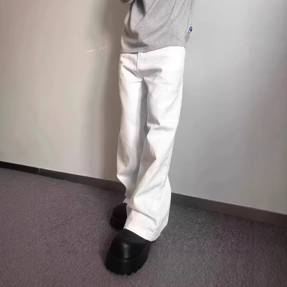 Man wearing white straight-leg cotton denim jeans with a wide leg opening.