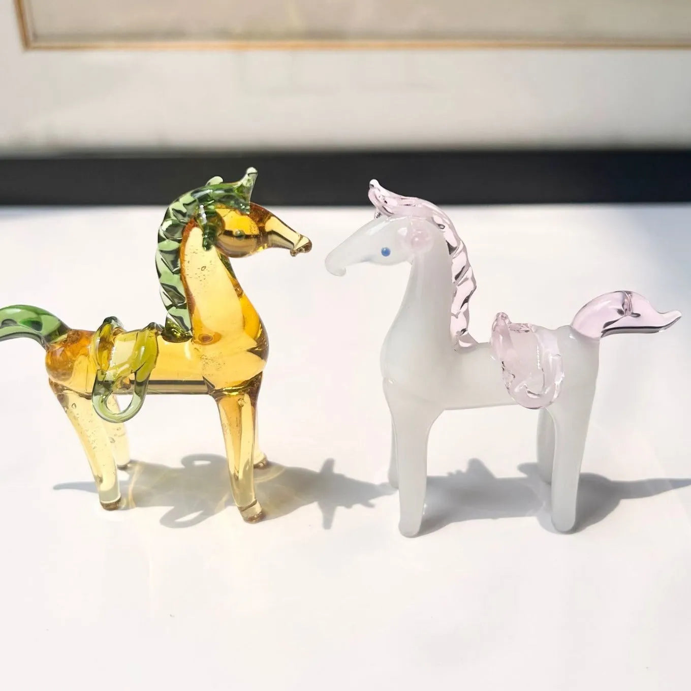 A smooth glazed horse figurine ornament in a modern minimalist style on a table.