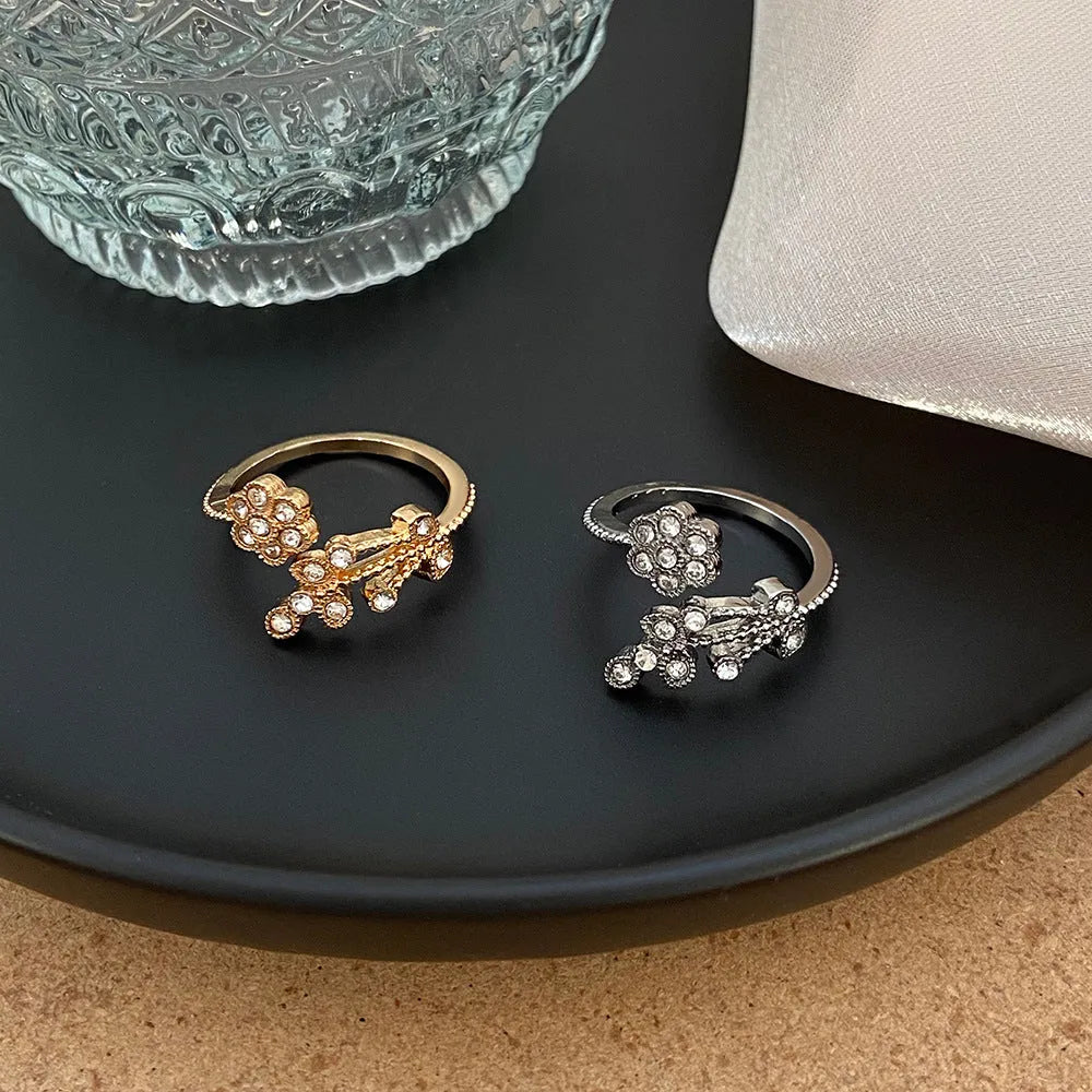 Copper open ring with flower and leaf design in gold or white diamond-treated finish