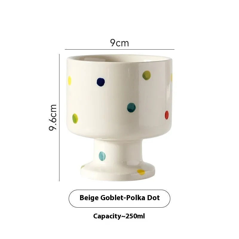 Handmade irregular solid colour ceramic mug on a table, showing its unique shape.