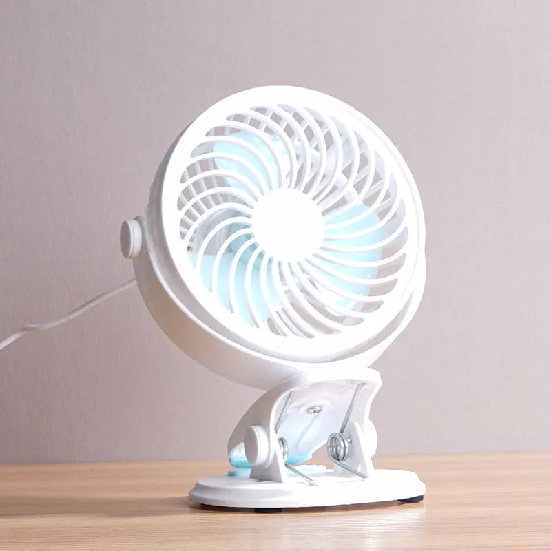 Small white USB desktop fan shown as a clip-on model and a floor-standing model on a wooden desk.