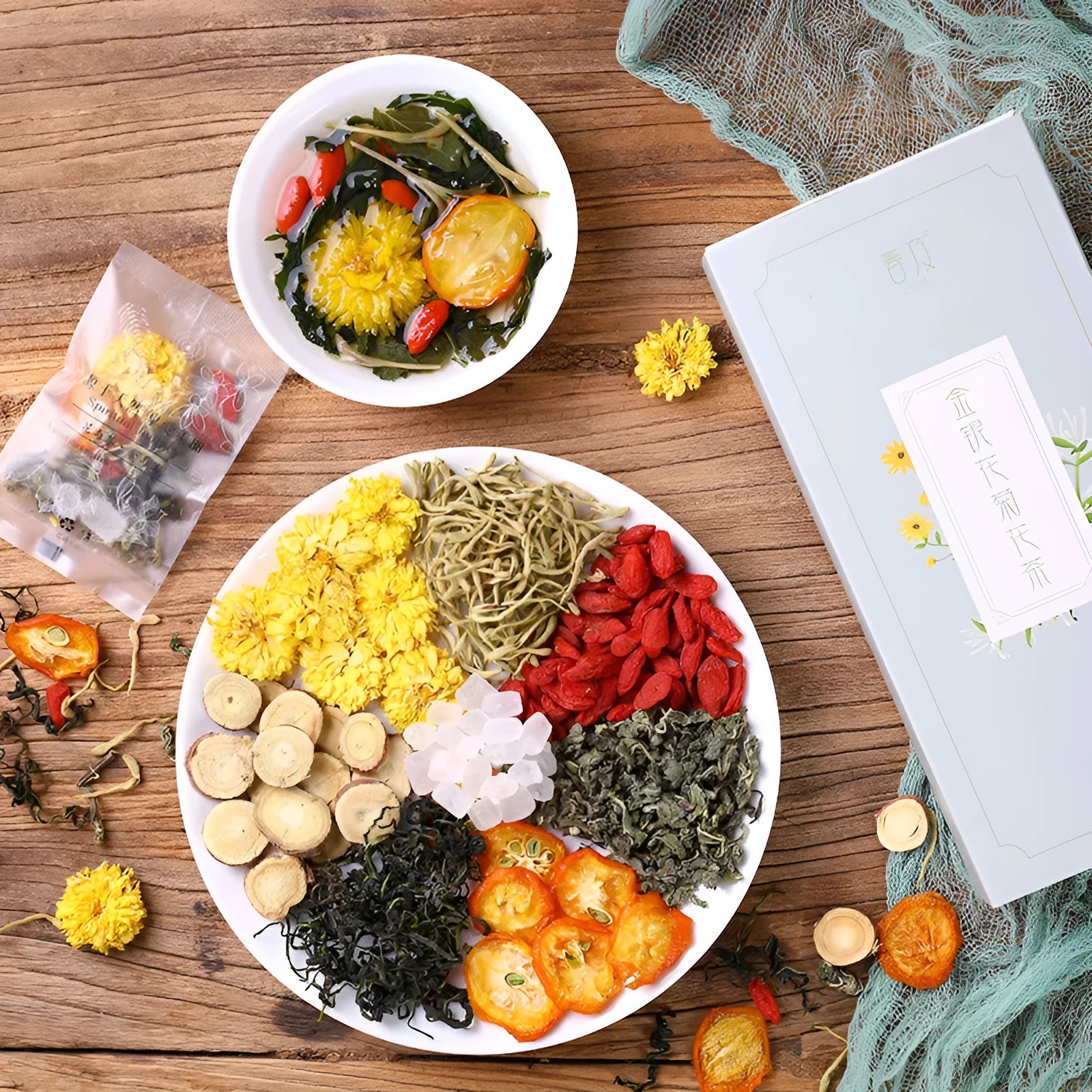 Box of honeysuckle chrysanthemum herbal tea showing packaging options and bonus teacups