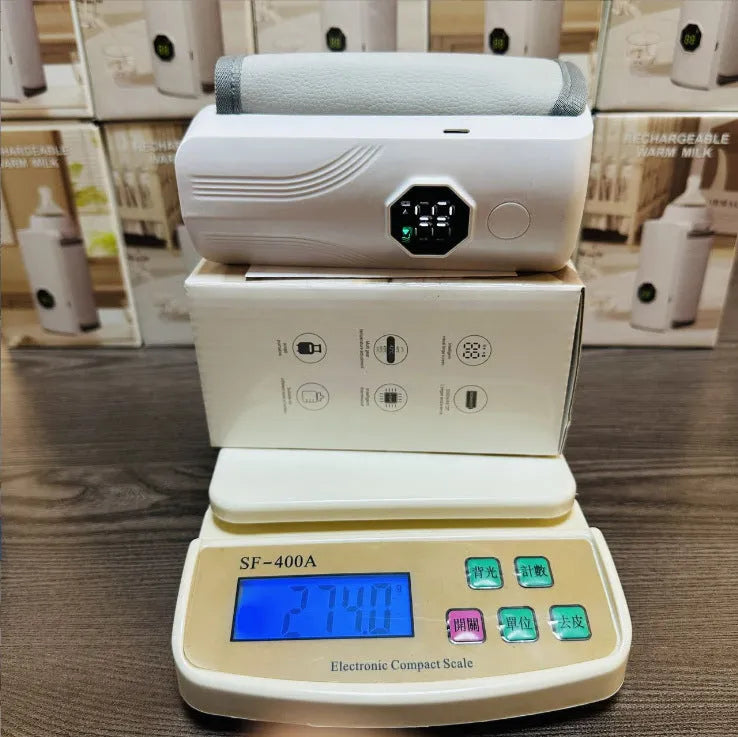 Grey and white car charger electric milk warmer for baby bottles on a 12V DC socket.