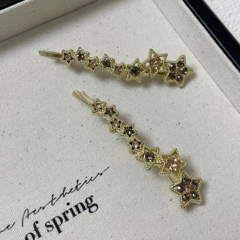 Gold electroplated alloy hair barrette with side clip and five-pointed star charm decoration