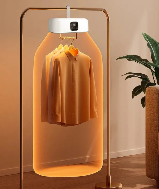White cylindrical portable laundry drier dryer with remote control on a countertop.