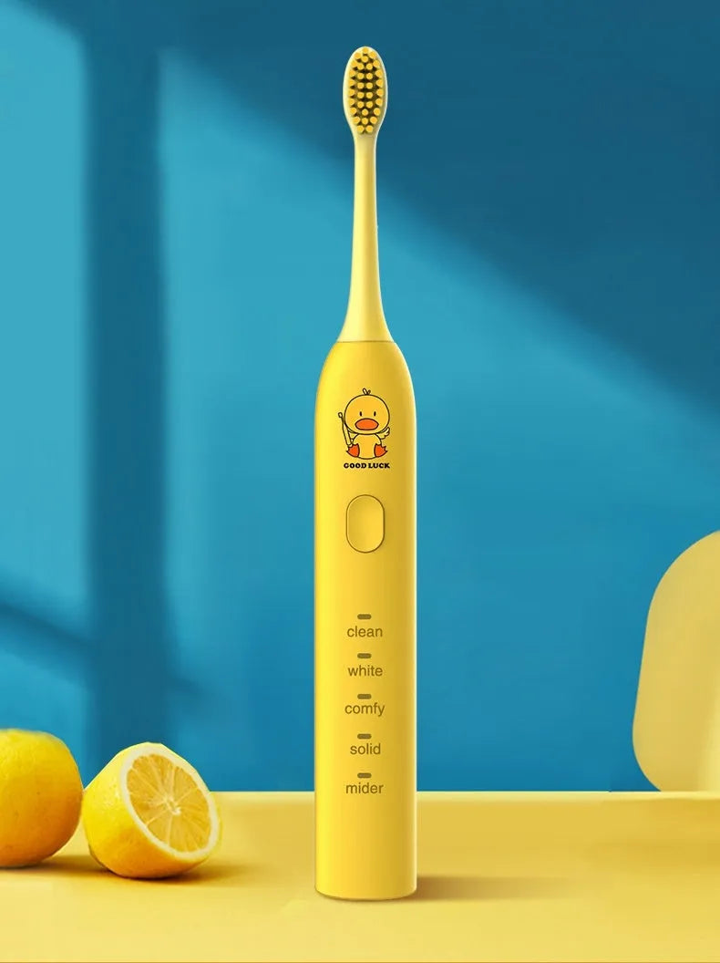 Yellow USB rechargeable adult electric toothbrush with small duck design and soft bristles.