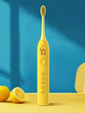 Yellow USB rechargeable adult electric toothbrush with small duck design and soft bristles.