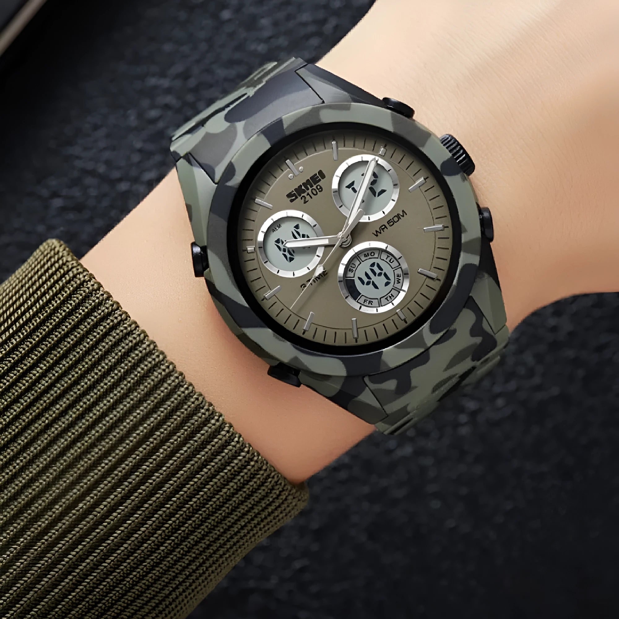 Unisex digital watch with camouflage strap and resin lens, showing time display and stainless steel buttons.