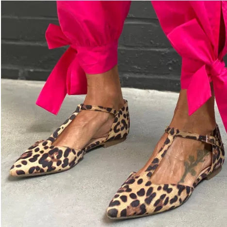 Leopard print women's pointed toe pumps with a low chunky heel and an ankle cross-strap.